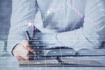 Financial trading chart multi exposure with man desktop background.