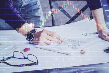 Financial trading chart double exposure with man desktop background.