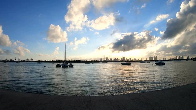 Boats by Miami Beach bay walk at sunset. Florida, USA