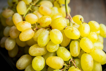 Ripe green grape on the rustic background. Selective focus. Shallow depth of field.