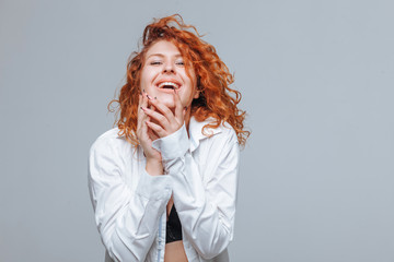 Cheerful Redhead girl laughing in black lingerie and white shirt