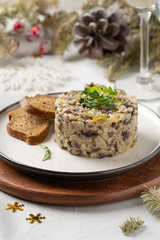 Salad with mushrooms, beef, potatoes and onions for new year, Christmas. Winter holiday, celebration, traditional Russian food. Portion feed