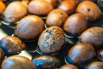 Chinese tea herbal eggs beneficial for general health at retail outlet. Boiled soy eggs for sell in street market in China town, Singapore