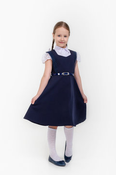 little girl in school uniform on white background
