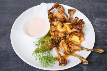 Chicken legs with melted cheese.