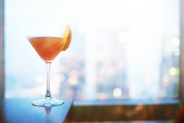 Cocktail glasses on the windowsill by the glass