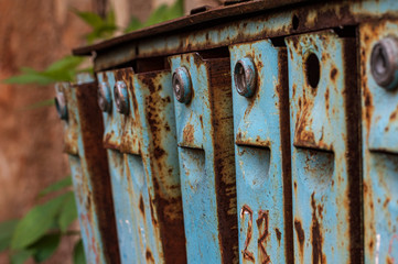 Old blue rust-coated iron mailboxes