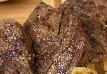 Mixed grilled meats platter closeup.
