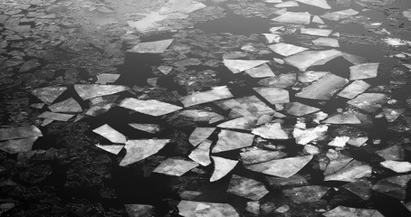 Drifting on the river. Fragments of ice float on river.