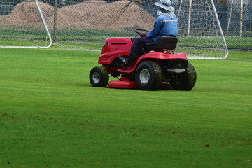 Mower and with a driver to take care of mowing in The football stadium always looks 