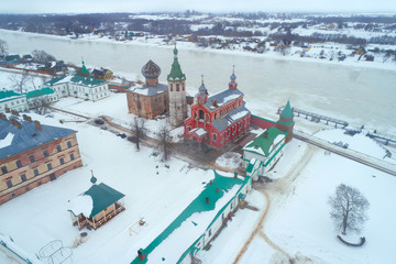 Temples of the Staroladozhsky Nicholas Monastery on the background of the Volkhov River on a cloudy...