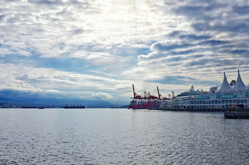 sunrise over the bay at downtown Vancouver. The first sun's rays shine through cirrus clouds. photo in light key