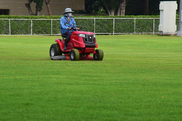 Mower and with a driver to take care of mowing in The football stadium always looks 
