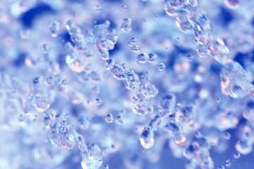 Water splashes, abstract surface, close-up. Blue and pink background