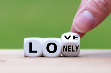 Fall in love concept. Hand turns a dice and changes the word 