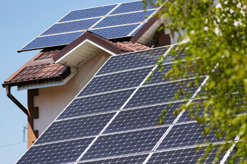 solar panels on the roof of the house, clean energy of the sun, renewable energy concept