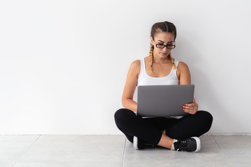 Attractive young woman typing on computer, enjoing writing blog or chatting with friends