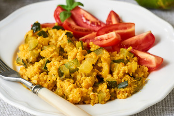 Spicy millet porridge with zucchini and tomatoes