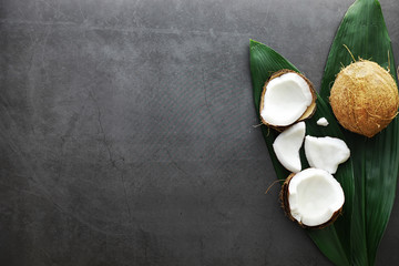 Fototapeta na wymiar Coconut on a dark stone table. Coconut oil.