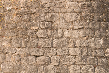 Background texture of the old fortress stone wall. Conceptual background for designers.