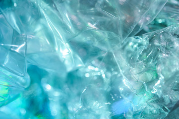 Holographic background in the style of the 80-90s. Real texture of cellophane film in bright acid colors.