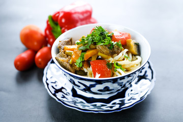 National asian tasty  dish lagman in a plate on table background