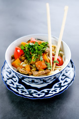 National asian tasty  dish lagman in a plate on table background