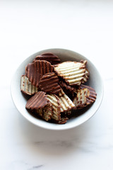 Japanese chocolate potato chips on a marble background with copy space