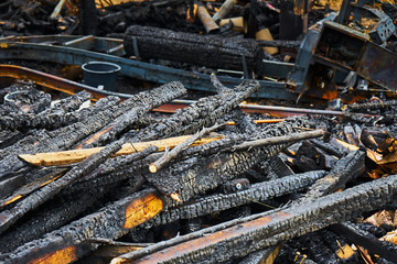 stack of burnt wood after a fire damage, of which only one fire ruin remained