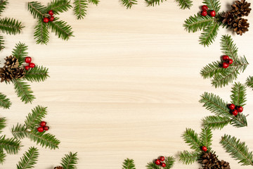 Christmas composition. Tree branches, pine cone and berries on wooden background. Christmas, winter, new year concept. Flat lay, top view, copy space