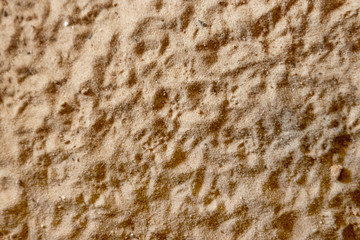 Beach yellow sand top view, sand texture, yellow background.