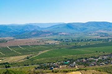 Fototapeta na wymiar Crimean landscape in the foreground cultivated fields and behind the low mountains.