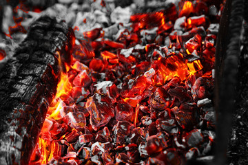 Texture red hot coals, selective focus. Barbecue grill dark background