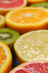 Fototapeta na wymiar Orange, grapefruit, kiwi sliced and slices. 