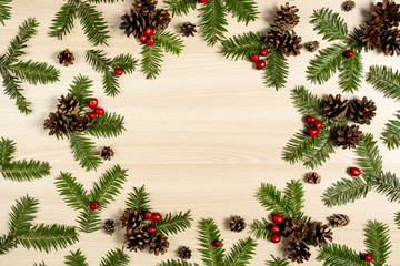Fototapeta na wymiar Christmas composition. Tree branches, pine cone and berries on wooden background. Christmas, winter, new year concept. Flat lay, top view, copy space