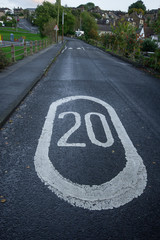 Drivers warned by a bold painted 20MPH sign in the road and speed bumps that they are approaching a playground
