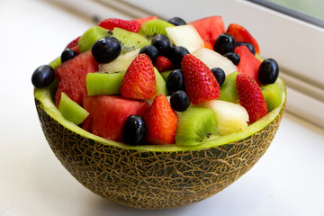 delicious bowl of fresh fruits and berries. Juicy and colorful background. Vegetarian food, summer concept. Organic healthy diet.