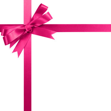 Pink gift ribbon bow vertical corner border frame isolated on white.