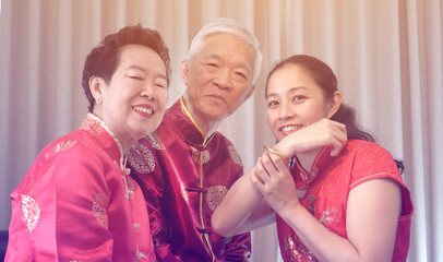 Asian parents give daughter in law gold bracket Chinese New Year