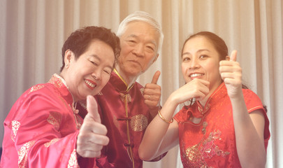 Asian parents give daughter in law thumb up Chinese New Year