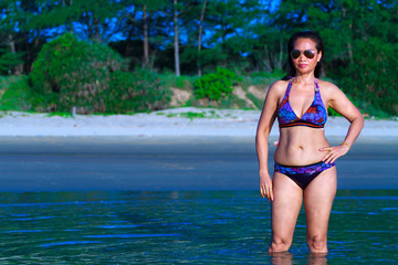 Woman shape pretty show bikini on beach