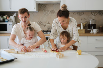 Caucasian family with two kids cooking together