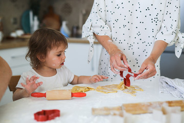 Mom and daughter Toddler together make cookies