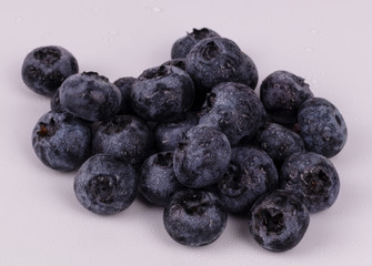 Blackberries with little drops of water on it on white background