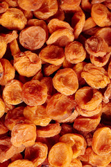 Background from appetizing dried apricots close-up