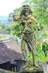 Balinese demon statue on pedestal