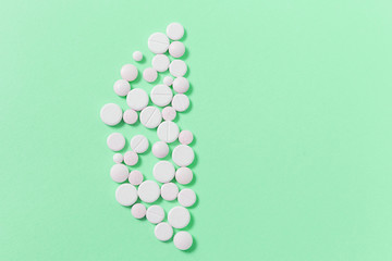 White medical pills on blue background.