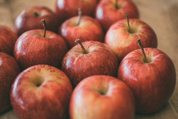 Ripe red apples as background, macro view of fresh and juicy apples. Healthy eating. Vegan food.
