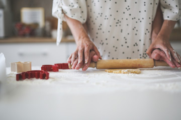 Cozy woman and man together make cookies in white