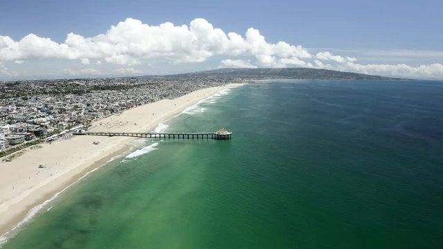 Aerial: A Neighborhood in Front of a Beach With a Pier Leading Out to the Ocean - Manhattan Beach, California